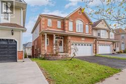 View of front of property with a garage and a front yard - 