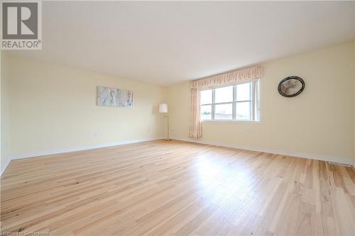 Unfurnished room featuring light hardwood / wood-style flooring - 584 Winterburg Walk, Waterloo, ON - Indoor