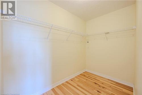 Walk in closet featuring wood-type flooring - 584 Winterburg Walk, Waterloo, ON - Indoor With Storage