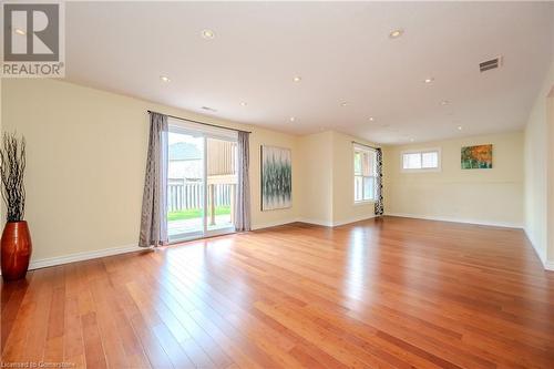 Empty room with a healthy amount of sunlight and light hardwood / wood-style floors - 584 Winterburg Walk, Waterloo, ON - Indoor