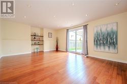 Empty room with light hardwood / wood-style flooring - 