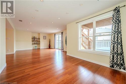 Unfurnished living room with hardwood / wood-style flooring - 584 Winterburg Walk, Waterloo, ON - Indoor Photo Showing Other Room