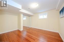 Basement with hardwood / wood-style flooring - 