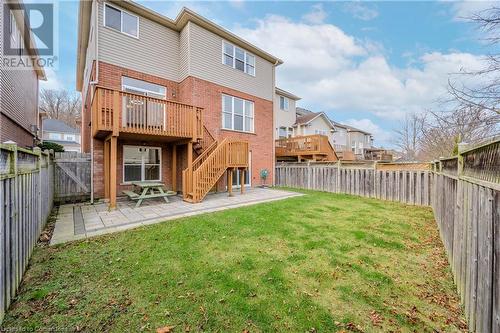 Rear view of property with a patio area, a yard, and a wooden deck - 584 Winterburg Walk, Waterloo, ON - Outdoor With Deck Patio Veranda With Exterior