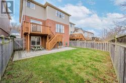 Rear view of property with a patio area, a yard, and a wooden deck - 