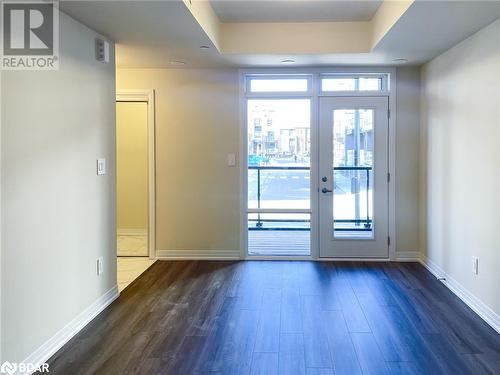 Doorway to outside with dark hardwood / wood-style floors and french doors - 1581 Rose Way Unit# 513, Milton, ON - Indoor Photo Showing Other Room