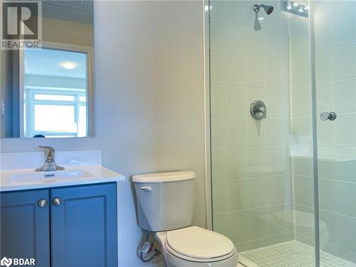 Bathroom featuring vanity, toilet, and tiled shower - 1581 Rose Way Unit# 513, Milton, ON - Indoor Photo Showing Bathroom