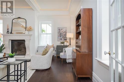 put a log on the fire and let it simmer while you relax - 49 James Street, Milton, ON - Indoor Photo Showing Living Room With Fireplace