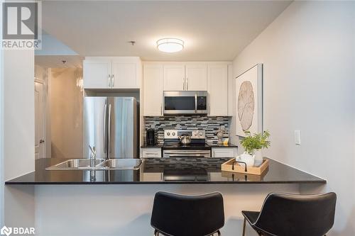 White Cabinetry w/ SS Appliances - 1421 Costigan Road Unit# 501, Milton, ON - Indoor Photo Showing Kitchen