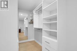 Primary bedroom walk-in closet - 