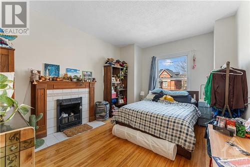 128 Flora Street, Ottawa Centre (4103 - Ottawa Centre), ON - Indoor Photo Showing Bedroom With Fireplace