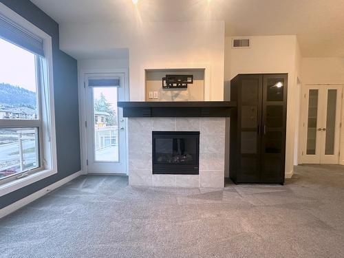 2402-7343 Okanagan Landing Road, Vernon, BC - Indoor Photo Showing Living Room With Fireplace