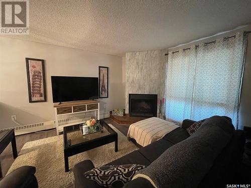 104 2511 Neff Road E, Regina, SK - Indoor Photo Showing Living Room With Fireplace