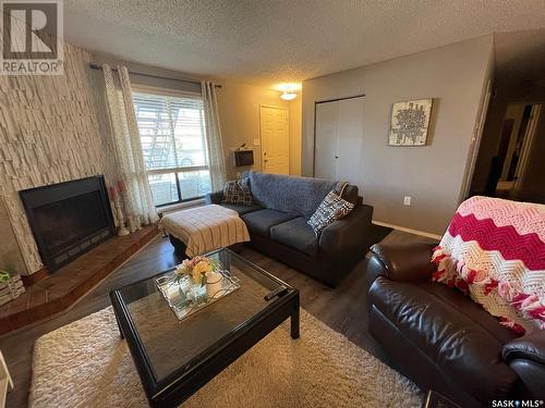 104 2511 Neff Road E, Regina, SK - Indoor Photo Showing Living Room With Fireplace