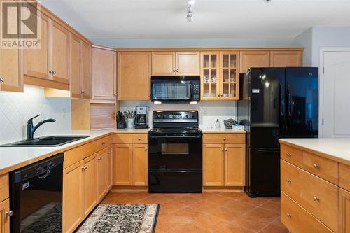 2101, 303 Arbour Crest Drive Nw, Calgary, AB - Indoor Photo Showing Kitchen With Double Sink