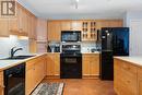 2101, 303 Arbour Crest Drive Nw, Calgary, AB  - Indoor Photo Showing Kitchen With Double Sink 