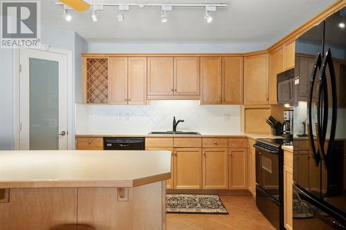 2101, 303 Arbour Crest Drive Nw, Calgary, AB - Indoor Photo Showing Kitchen With Double Sink