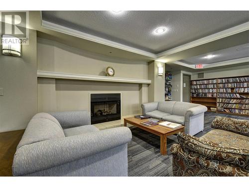 Library/Common Room - 1045 Sutherland Avenue Unit# 302, Kelowna, BC - Indoor Photo Showing Living Room With Fireplace