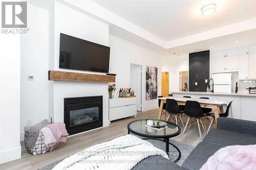 201 - 8 Wellesley Street, Toronto, ON - Indoor Photo Showing Living Room With Fireplace