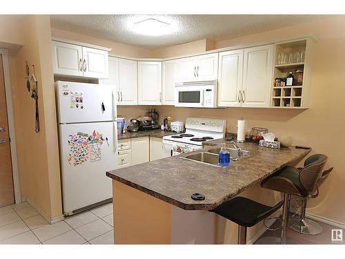 #216 17404 64 Av Nw, Edmonton, AB - Indoor Photo Showing Kitchen With Double Sink