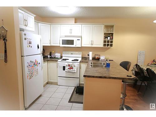 #216 17404 64 Av Nw, Edmonton, AB - Indoor Photo Showing Kitchen With Double Sink