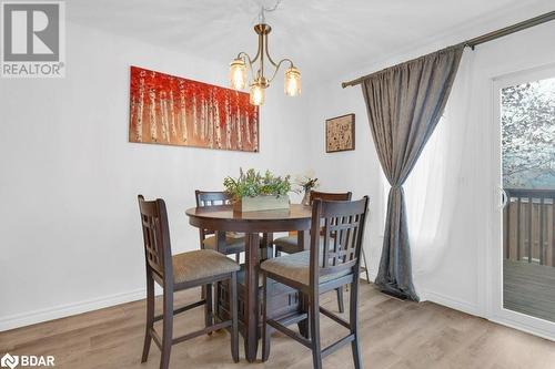 Dining room featuring hardwood / wood-style flooring and an inviting chandelier - 35 Albion Street Unit# 37, Belleville, ON - Indoor Photo Showing Dining Room