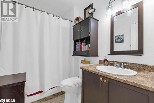 Full bathroom with tile patterned flooring, vanity, shower / bath combination with curtain, and toilet - 35 Albion Street Unit# 37, Belleville, ON - Indoor Photo Showing Bathroom