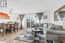 Living room with hardwood / wood-style floors and an inviting chandelier - 