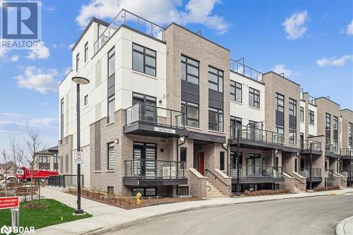 View of building exterior - 1569 Rose Way Unit# 104, Milton, ON - Outdoor With Balcony With Facade