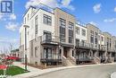 View of building exterior - 1569 Rose Way Unit# 104, Milton, ON  - Outdoor With Balcony With Facade 