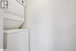 Laundry room featuring stacked washer and clothes dryer - 