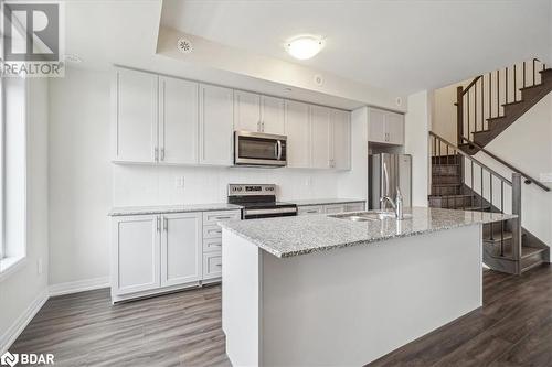 Kitchen featuring sink, white cabinets, and appliances with stainless steel finishes - 1569 Rose Way Unit# 104, Milton, ON - Indoor Photo Showing Kitchen With Stainless Steel Kitchen With Upgraded Kitchen