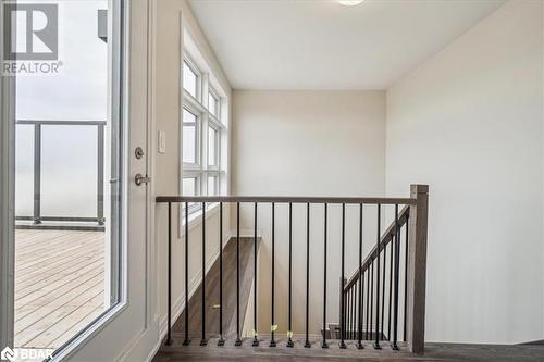 Stairway with wood-type flooring - 1569 Rose Way Unit# 104, Milton, ON - Indoor Photo Showing Other Room