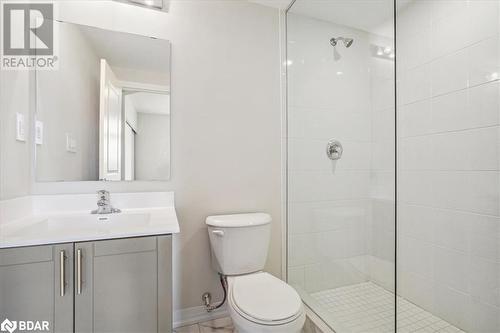 Bathroom with a tile shower, vanity, and toilet - 1569 Rose Way Unit# 104, Milton, ON - Indoor Photo Showing Bathroom