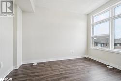 Unfurnished room with dark wood-type flooring - 