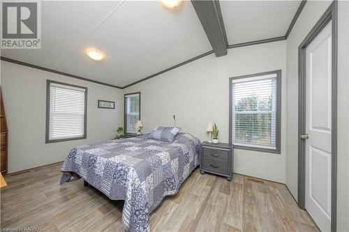 Bedroom featuring lofted ceiling with beams, light hardwood / wood-style floors, and ornamental molding - 112 Meadowview Lane, Listowel, ON - Indoor Photo Showing Bedroom