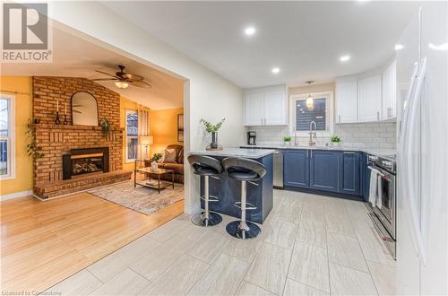 Kitchen with access to sunken Family room - 6 Fran Ellen Crescent, Kitchener, ON - Indoor Photo Showing Kitchen With Fireplace