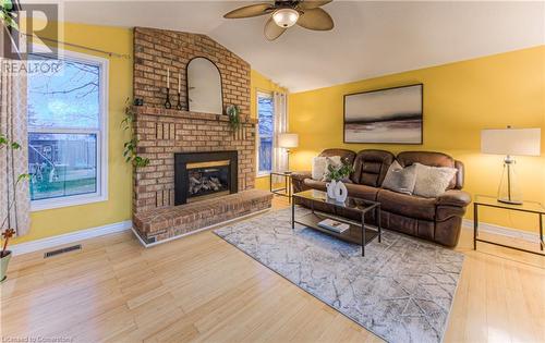 Family room featuring ceiling fan, a gas fireplace, lofted ceiling, and bamboo hardwood flooring - 6 Fran Ellen Crescent, Kitchener, ON - Indoor Photo Showing Living Room With Fireplace