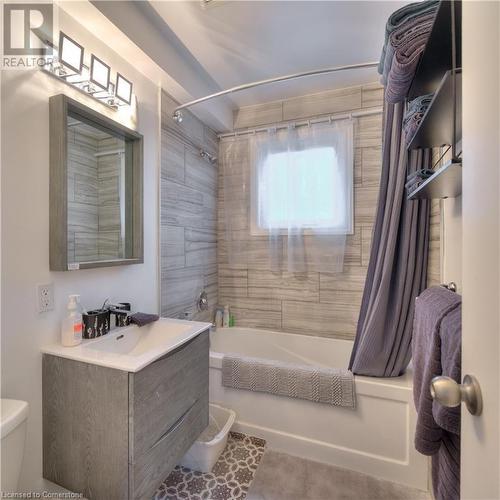 Full bathroom with tile patterned floors, vanity, shower / bath combination with curtain, and toilet - 524 Krug Street, Kitchener, ON - Indoor Photo Showing Bathroom