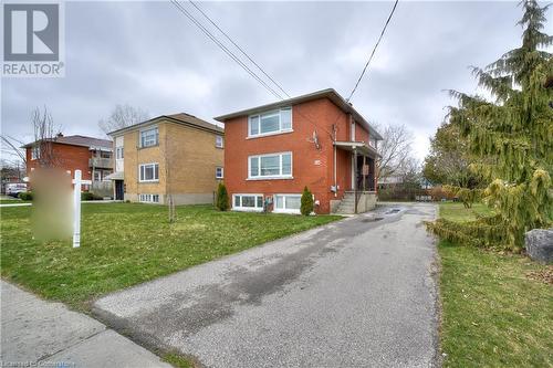 View of side of home featuring a lawn - 524 Krug Street, Kitchener, ON - Outdoor