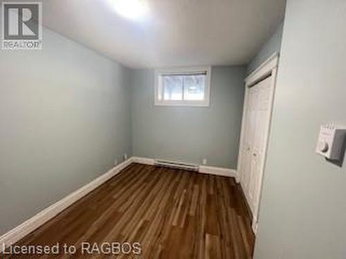 Unfurnished bedroom with a closet and dark wood-type flooring - 745 4Th Avenue East Avenue, Owen Sound, ON 