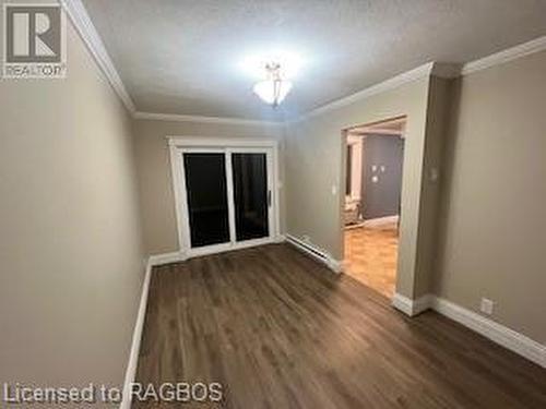 Spare room with a textured ceiling, dark hardwood / wood-style floors, and crown molding - 745 4Th Avenue East Avenue, Owen Sound, ON 