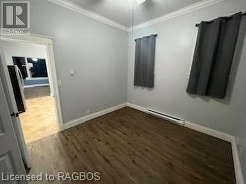 Unfurnished room featuring ceiling fan, dark hardwood / wood-style flooring, and crown molding - 745 4Th Avenue East Avenue, Owen Sound, ON 