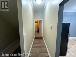 Hallway featuring crown molding and wood-type flooring - 