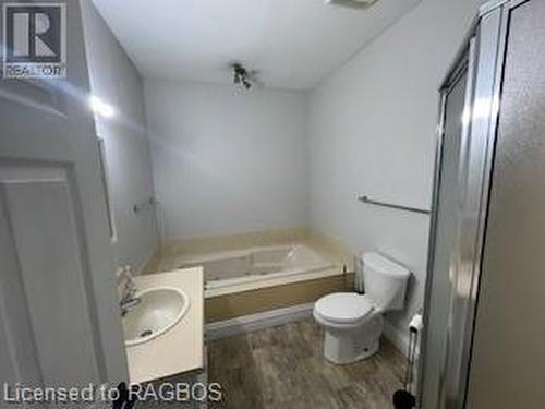 Bathroom featuring a washtub, vanity, wood-type flooring, and toilet - 745 4Th Avenue East Avenue, Owen Sound, ON 