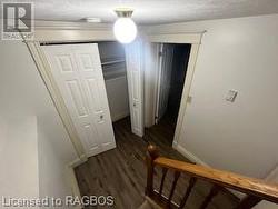 Hall featuring dark hardwood / wood-style floors and a textured ceiling - 