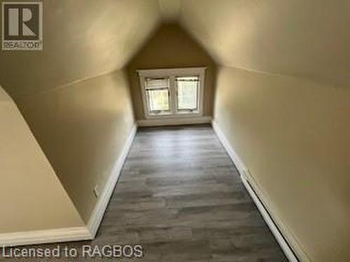 Bonus room with a baseboard radiator, dark wood-type flooring, and vaulted ceiling - 745 4Th Avenue East Avenue, Owen Sound, ON 