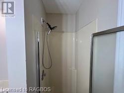 Bathroom featuring a shower with door - 