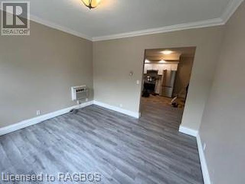 Unfurnished room featuring a wall mounted air conditioner, dark hardwood / wood-style flooring, and crown molding - 745 4Th Avenue East Avenue, Owen Sound, ON 