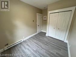 Unfurnished bedroom featuring a closet and hardwood / wood-style floors - 